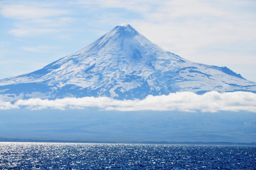 white and black mountain under white clouds during daytime