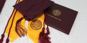 black academic hat on yellow textile